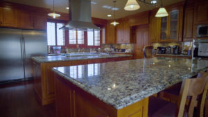 dark themed kitchen with custom cabinets and countertops