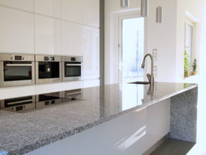 Minimalist modern kitchen with a long beautiful granite countertop