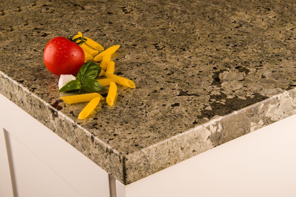 close up of kitchen granite countertop with tomato and pasta on it